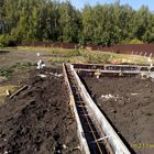 Фундамент на забивных ж/б сваях с бетонным ростверком для хозяйственной постройки из бруса с гаражом и подвалом в городе Грязи Липецкой области от компании 35FS